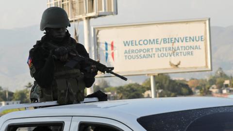 Haitian soldiers patrol outside the Toussaint Louverture International Airport following a gunfight with armed gangs