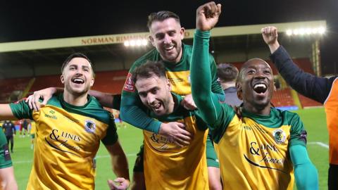 Horsham players celebrate after earning a replay against Barnsley