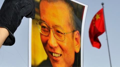 A protester holds an image of jailed dissident Liu Xiaobo outside the Chinese Embassy in Oslo, Norway 9 December 2010