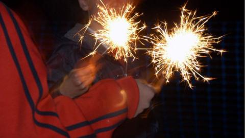 Children playing with sparklers