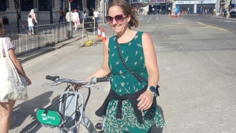 Sarah Scire gyda beic Nextbike