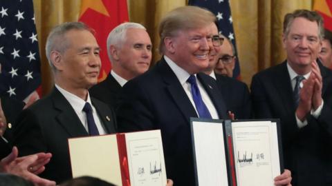 US President Donald Trump and Chinese Vice Premier Liu He, hold up signed agreements of phase 1 of a trade deal.