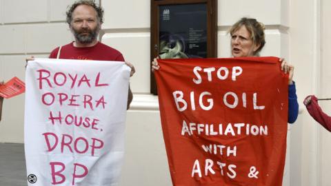 Environmental Activists from Extinction Rebellion outside the Royal Opera House in London in 2019 demand that they drop gas and oil British Petroleum (BP) as a sponsor.