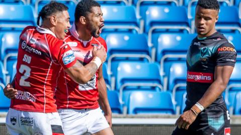 Kallum Watkins celebrates with Ken Sio