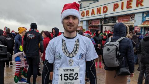 The mayor in his running gear standing outside of the Grand Pier