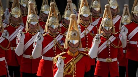 Royal guards march during the ceremonial procession from Buckingham Palace to Westminster Hall