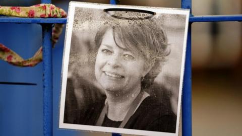 A photograph of Ruth Perry attached to railings