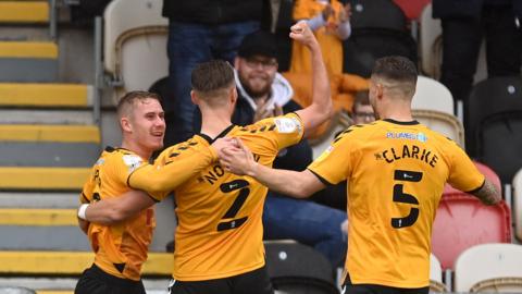 Ollie Cooper of Newport County celebrates scoring the opening goal