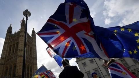 Union Jack and EU flag being flown outside Parliament