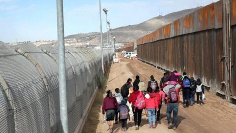 Central American immigrants cross the Rio Grande from Mexico into n El Paso, Texas, 1 February 2019