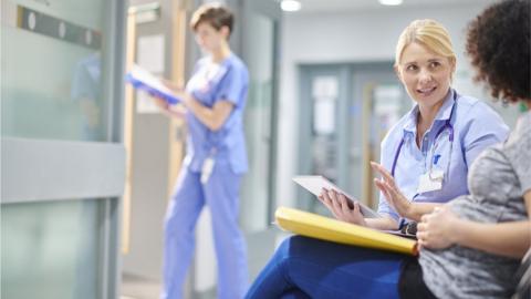 Woman chatting to a female doctor