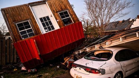 An ambulance arrives at Rolling Fork, Mississippi, which was devastated by a tornado, 25 March