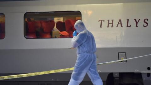 Police walk on a platform next to a Thalys train after the shooting