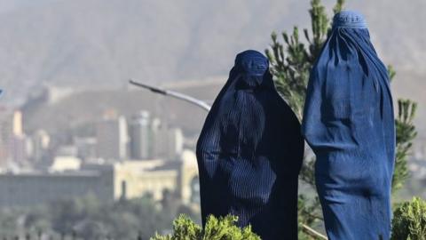 Two women wearing burqas
