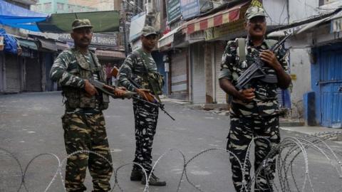 Security personnel stand guard at a roadblock ahead of Muslim's Friday noon prayers in Jammu.