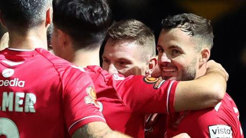 Wrexham's Paul Mullin is congratulated by team-mates