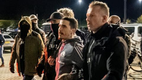 Legia Warsaw players being led away by police