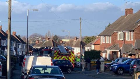Firefighters at the scene of a house fire in Defford Drive