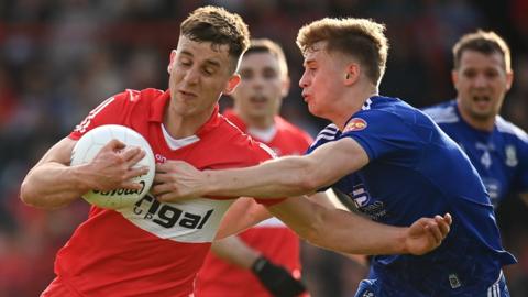 Monaghan's Karl Gallagher challenges Derry's Shane McGuigan