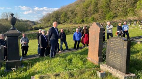 People gathered as a graveside