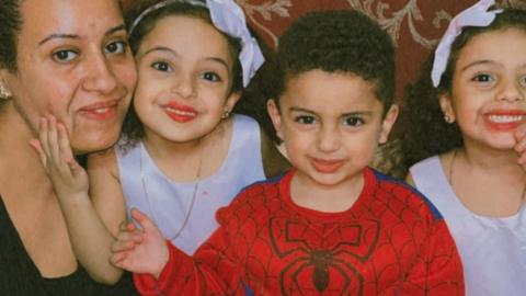 Family photo showing five-year-old twins Mariam and Barsina Wajih and their three-year-old brother Ibram with their mother
