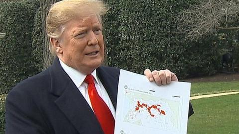 Donald Trump holding a map