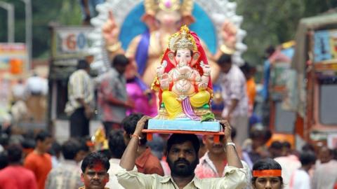 Indian devotees carry home idols of the elephant headed Hindu God Lord Ganesha through the streets of Mumbai