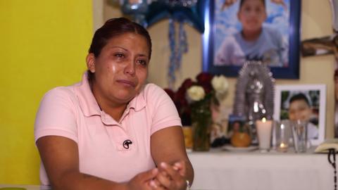 Marisol Tapia sits in front of an altar she has erected for her son Brandon