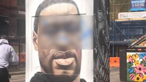 George Floyd mural with offensive word blurred
