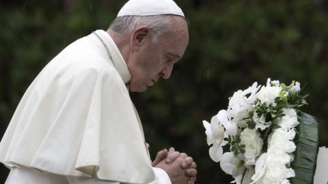 Pope Francis prays after laying a wreath to the Hypocenter Cenotaph at the Atomic Bomb Hypocenter Park