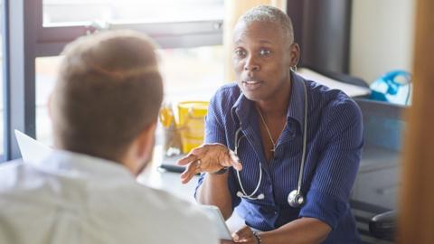 A GP chats to a patient