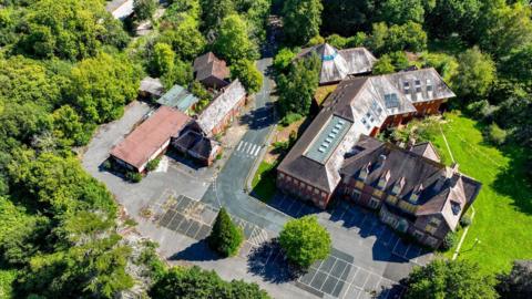 Aerial view of Furzehill council offices and car park surrounded by trees