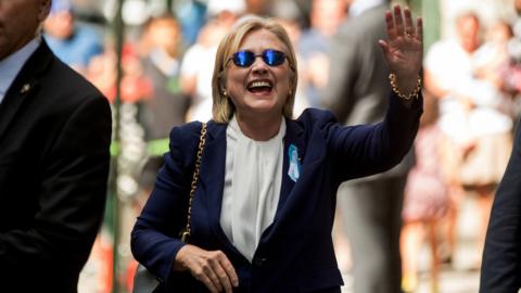 Democratic presidential candidate Hillary Clinton waves after leaving an apartment building in New York