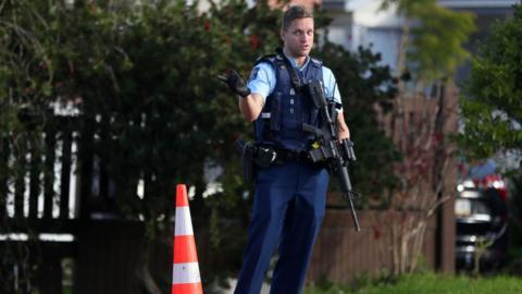 An armed officer at the scene of the shooting
