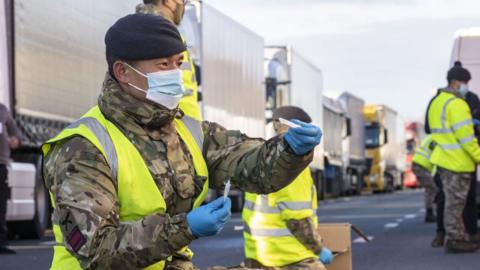 Military personnel helping test lorry drivers for Covid-19