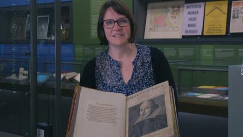 Museum curator with Shakespeare's First Folio