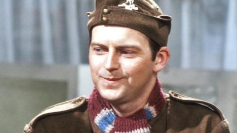 Ian Lavender as Private Pike wearing claret and blue scarf