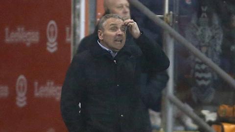 Carlisle United manager Paul Simpson watches his team lost at Blackpool