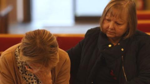Constituent Ruth Verrinder and former councillor and mayor Judith McMahon (L) pay their respects at St Michael All Angels Church, following the stabbing of UK Conservative MP Sir David Amess.
