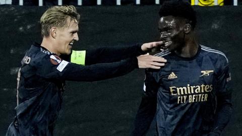 Arsenal's Bukayo Saka celebrates with Martin Odegaard after scoring against Bodo/Glimt in the Europa League