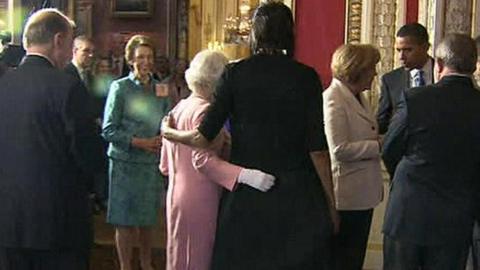 The Queen and Michelle Obama place their arms around each other at Buckingham Palace reception in 2009