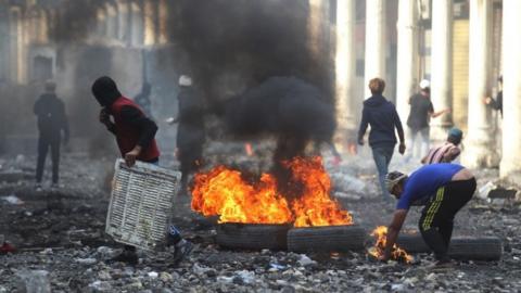 Protesters near the Ahrar Bridge in Baghdad, where at least four people died