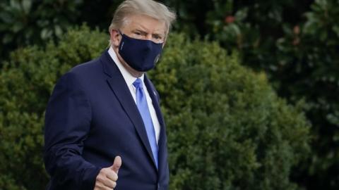 Donald Trump gives a thumbs up as he leaves White House for hospital