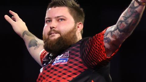 Michael Smith celebrates beating Gerwyn Price in the PDC World Darts Championship