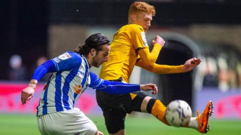 Jamie Sterry of Hartlepool United clears under pressure from Newport's Ryan Hayes