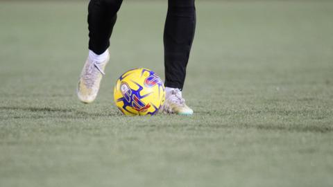 General image of player warming up on the frozen pitch at Accrington's Wham Stadium home ground