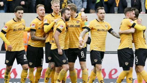 Dresden players celebrate scoring a goal