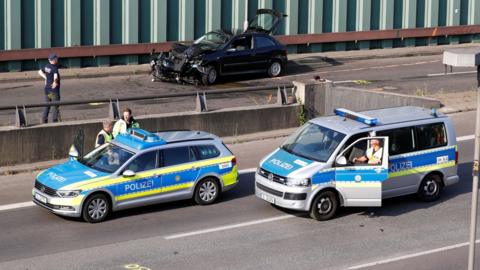 Police officers investigate the scene of a series of allegedly deliberate car crashes on highway A100 in Berlin, Germany, August 19, 2020
