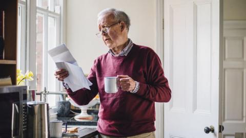 old man reading letter