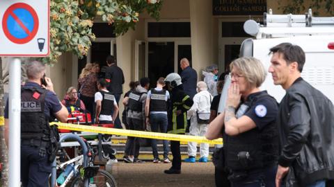 French police officers from the forensic service stand in front of the Gambetta high school in Arras, northeastern France on October 13, 2023